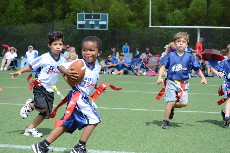 Kids playing flag football in custom team jerseys